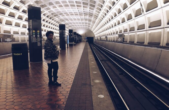 Monica standing at a metro stop in DC.