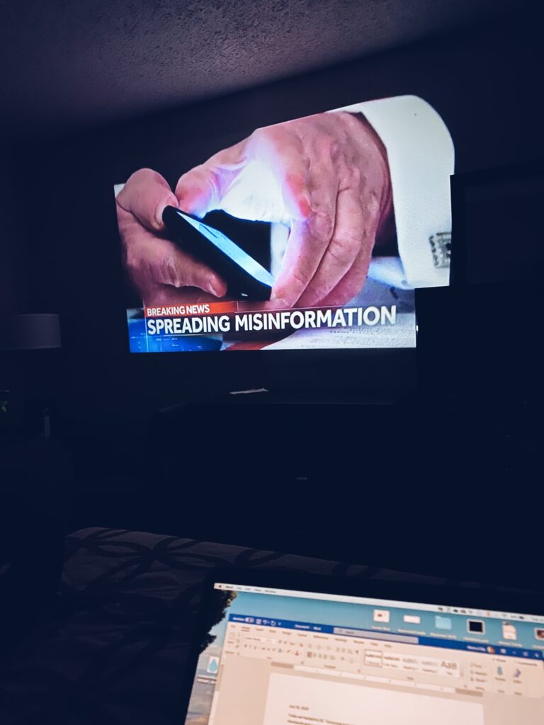 An image of the news projected on the wall of the hotel room.