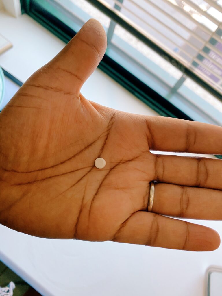 Birth control pill in Monica's hand